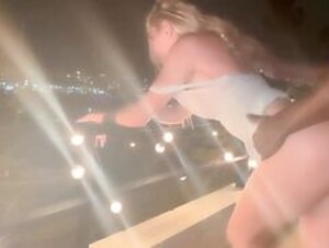 Blonde-Slut-Takes-Huge-BBC-in-her-Throat-and-Gets-Railed-on-the-Railing-of-her-Balcon